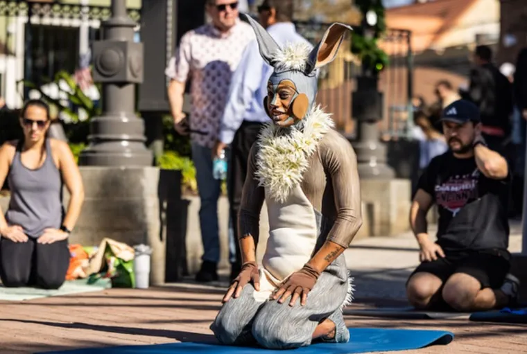 Cirque du Soleil performer participating in an open air yoga class at Disney Springs