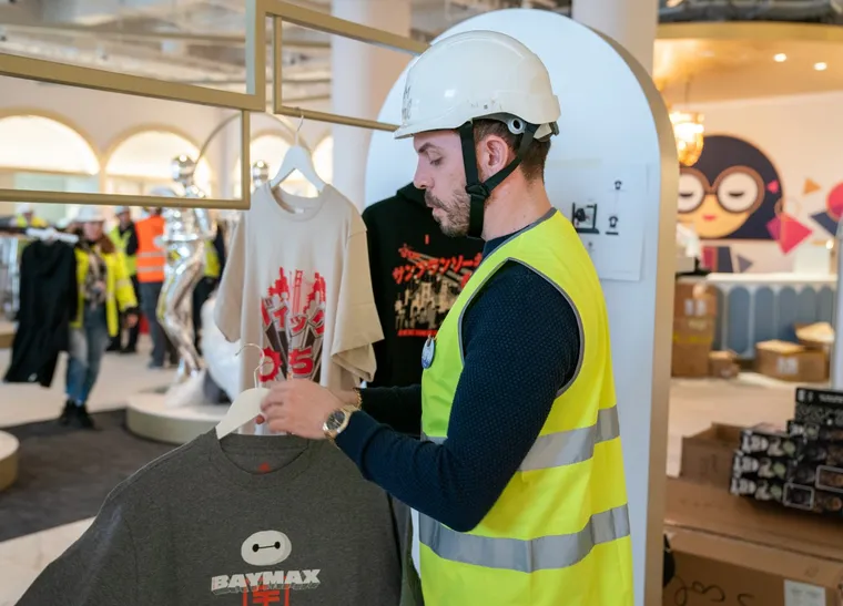 Disney castmember preparing for the store opening at Disney Style, at Disney Village, Disneyland Paris